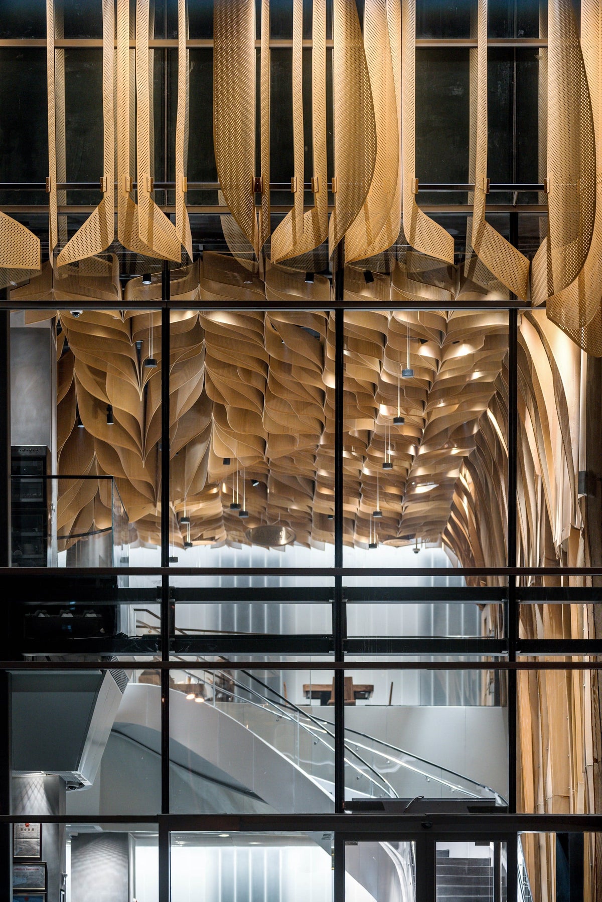Banu Restaurant with an undulating perforated metal ceiling