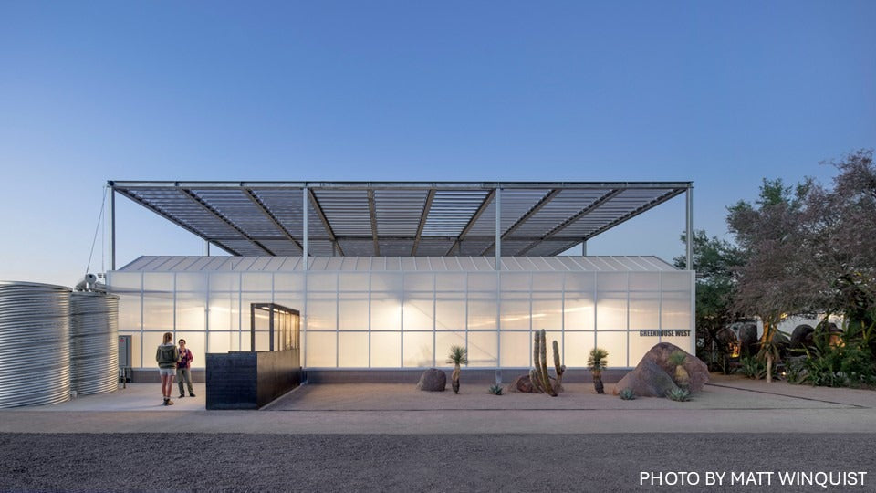Perforated metal louver array above a desert botanical garden greenhouse