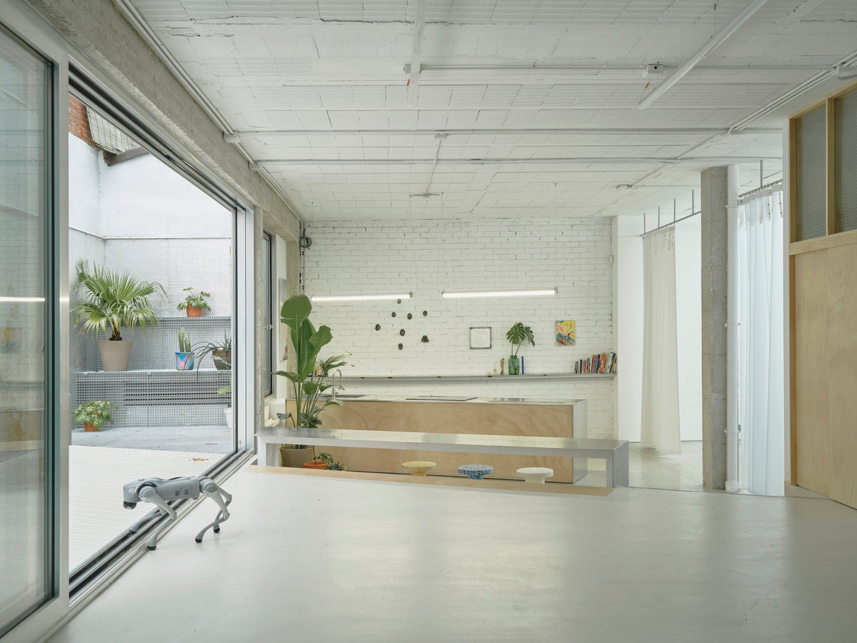 Hybrid Infrastructure Doble Erre in Madrid with reflective metal surfaces and a flexible cultural workspace
