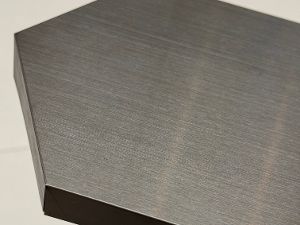 Brushed stainless steel architectural panel showing the decorative surface and folded edge; alloy grade not inferred