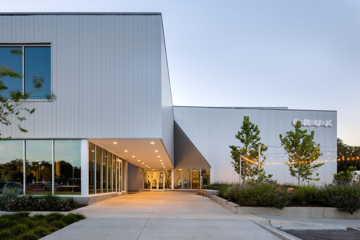 Crux South climbing gym with a dark metal-clad exterior and entrance canopy in Austin