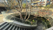 Curved stainless steel honeycomb panel cladding beside the garden staircase at Pazhou Yue, Guangzhou