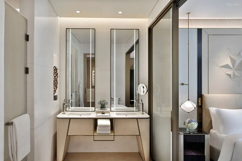 Hotel bathroom vanity with custom stainless steel mirror cabinet detailing