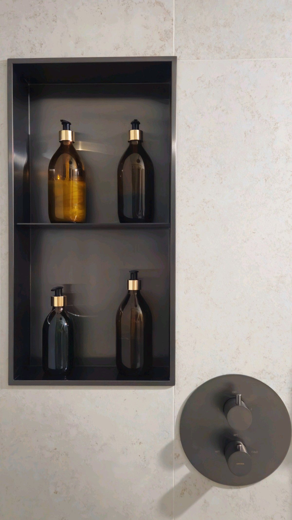 Custom stainless steel shower niche with recessed storage shelves