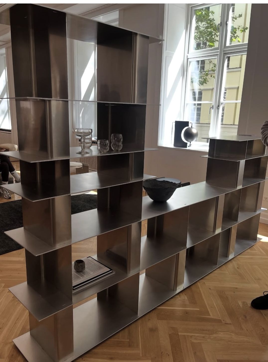Custom freestanding stainless steel bookshelf with open display shelving