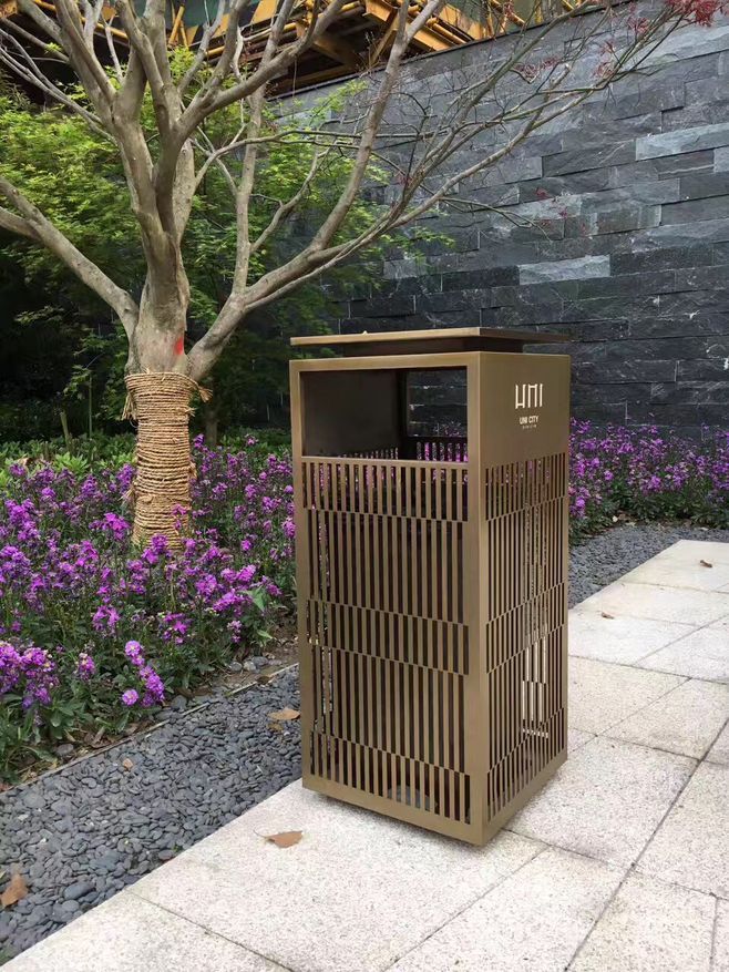 Architectural stainless steel hotel waste receptacle with bronze-toned finish