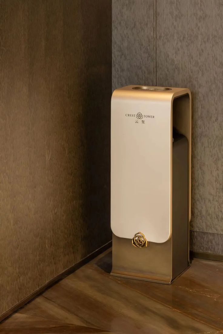 Architectural stainless steel hotel waste receptacle with bronze-toned finish