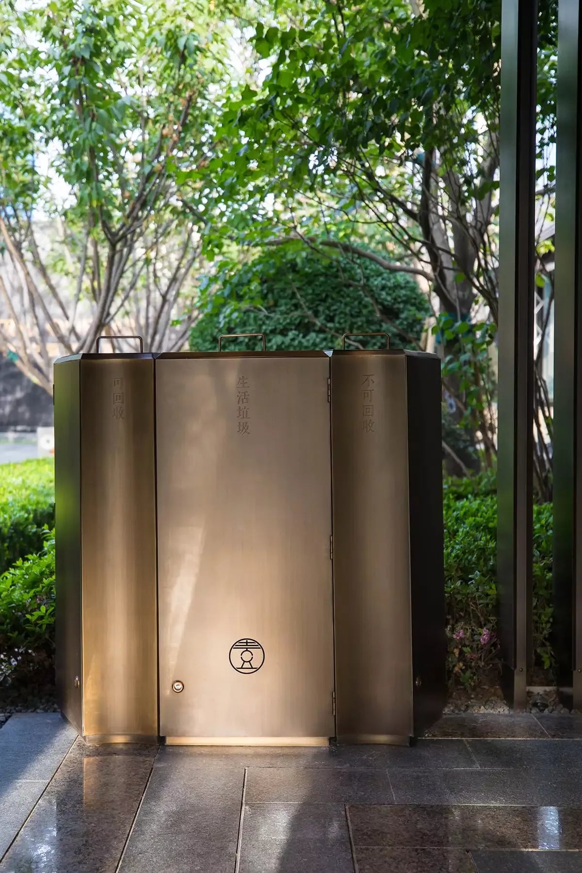Architectural stainless steel hotel waste receptacle with bronze-toned finish