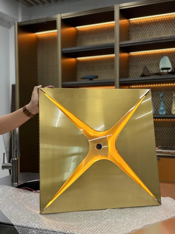 Angled view of gold folded metal star ceiling module sample