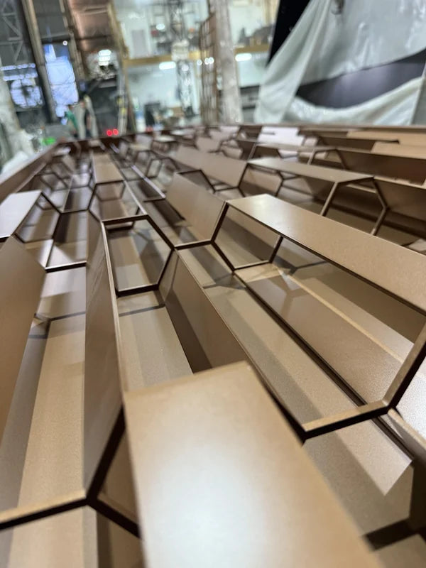 Frame and edge detail of bronze 3d faceted steel screen panel