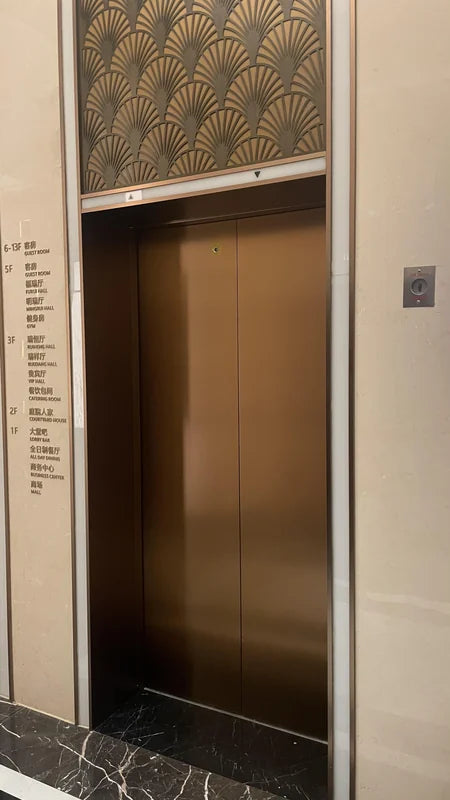 Bronze-Tone Elevator Door Surround with Patterned Transom