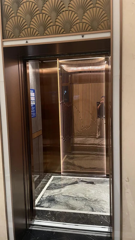 Open bronze elevator with patterned head panel for custom Xinmao Metal elevator design