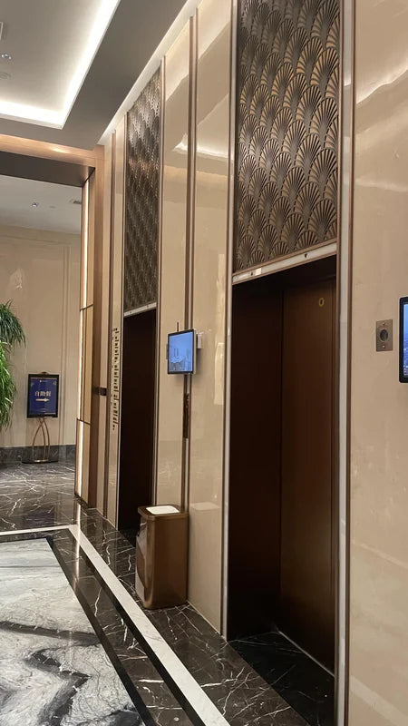 Paired elevator entrances with bronze framing for custom Xinmao Metal elevator design