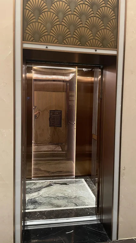 Open elevator entrance with bronze interior and transom for custom Xinmao Metal elevator design