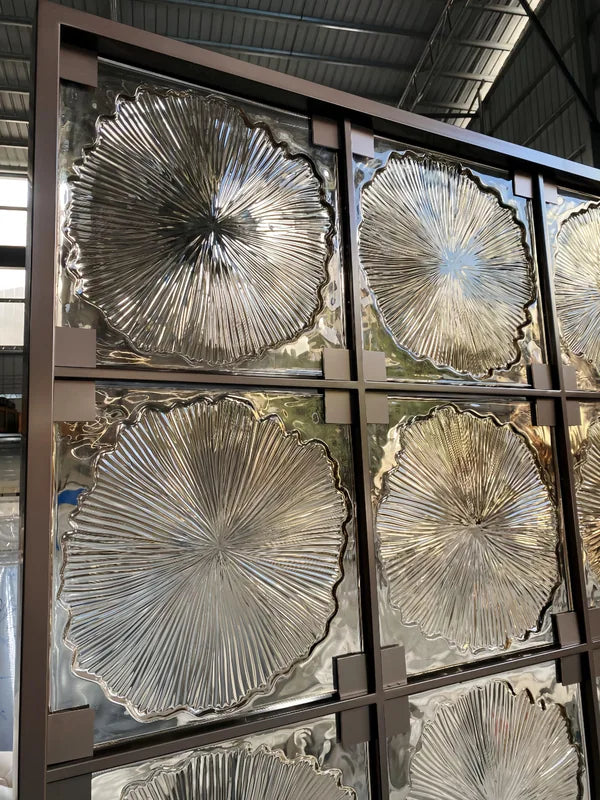 Surface and edge detail of bronze floral textured glass folding screen