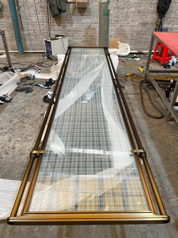 Overall workshop view of bronze glass steel screen with tubular frame