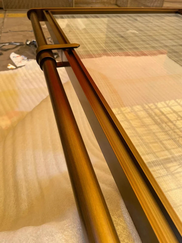 Angled panel view of bronze glass steel screen with tubular frame