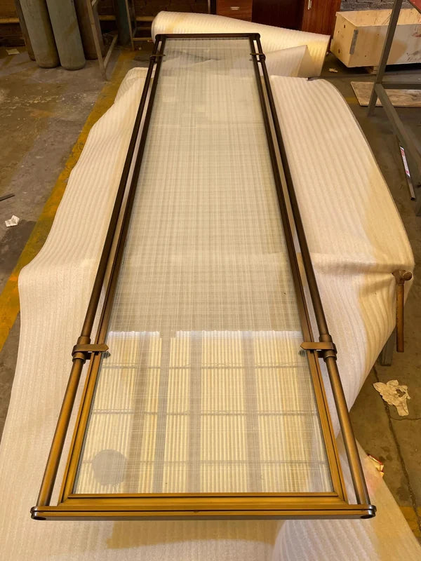 Fabrication view of bronze glass steel screen with tubular frame