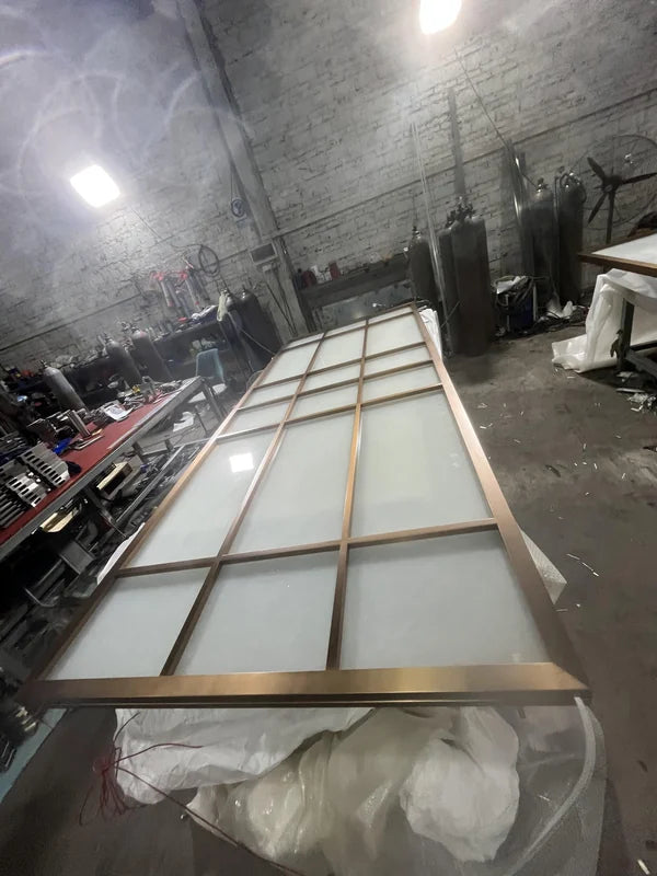 Overall workshop view of bronze linear grille steel screen options