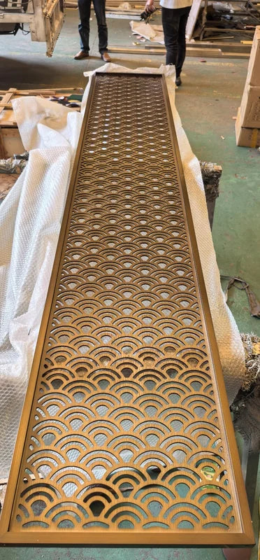 Overall workshop view of bronze seigaiha wave laser cut steel screen