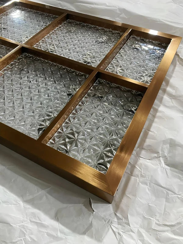 Surface and edge detail of bronze star textured glass stainless steel screen panel