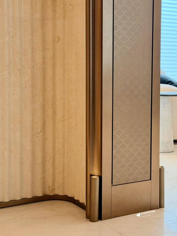 Close view of bronze jamb and textured side panel for custom Xinmao Metal elevator design