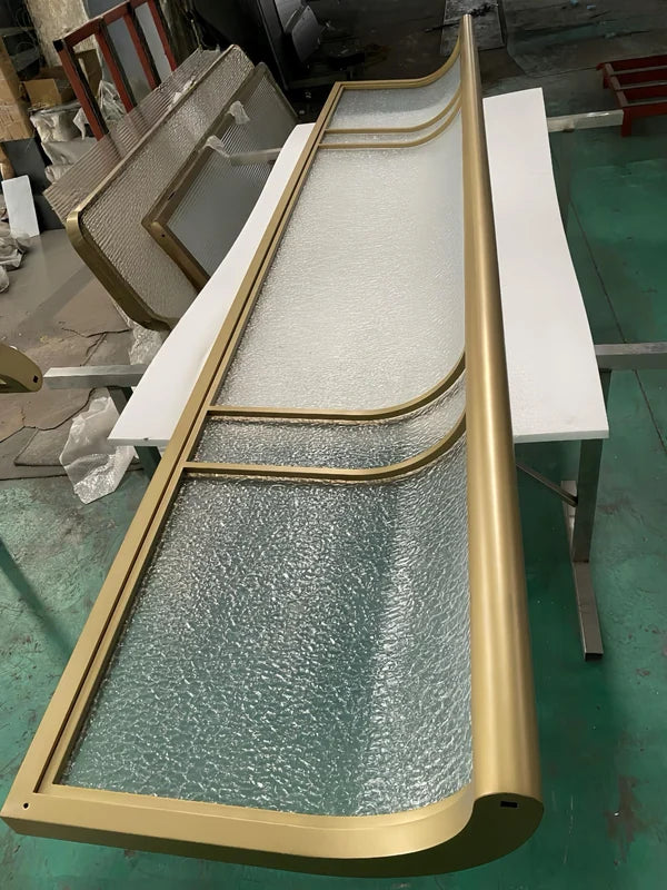 Angled screen view of curved bronze textured glass stainless steel screen