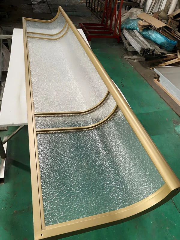 Frame detail of curved bronze textured glass stainless steel screen