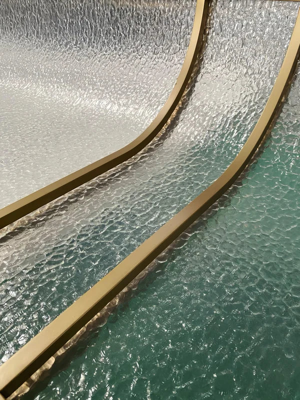 Assembly view of curved bronze textured glass stainless steel screen