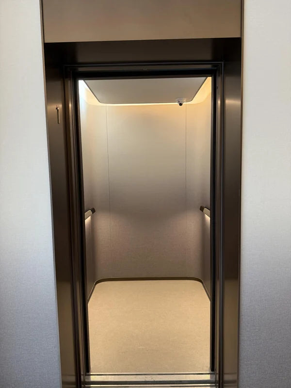 Open elevator entrance showing light cabin interior for custom Xinmao Metal elevator design
