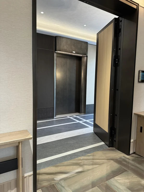 Lobby approach showing metal door and wall cladding for custom Xinmao Metal elevator design