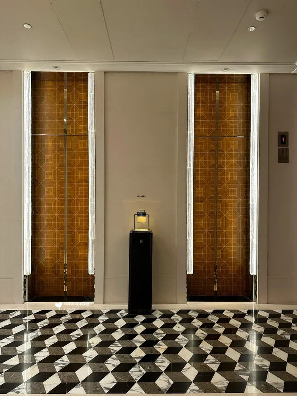 Paired bronze elevator doors with patterned side panels for custom Xinmao Metal elevator design