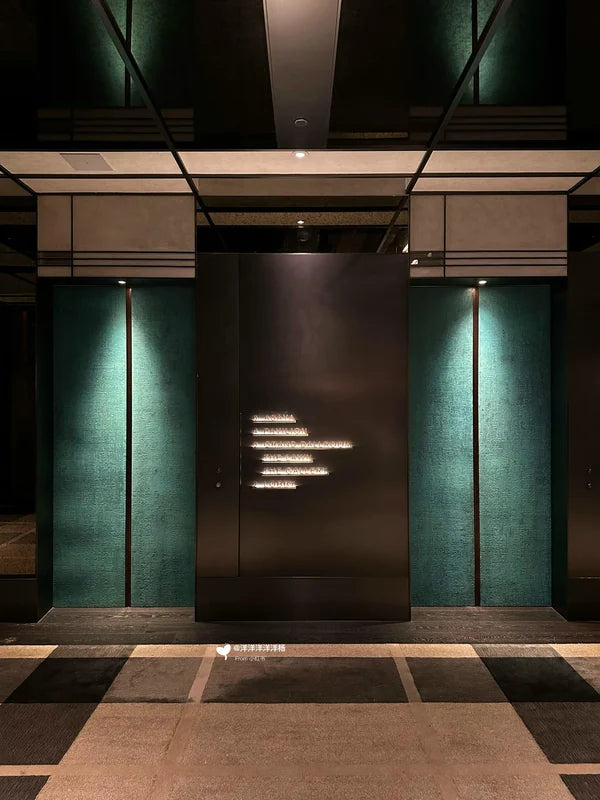 Dark lift doors with green flanking panels for custom Xinmao Metal elevator design