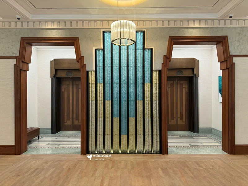 Paired lift portals beside decorative screen for custom Xinmao Metal elevator design