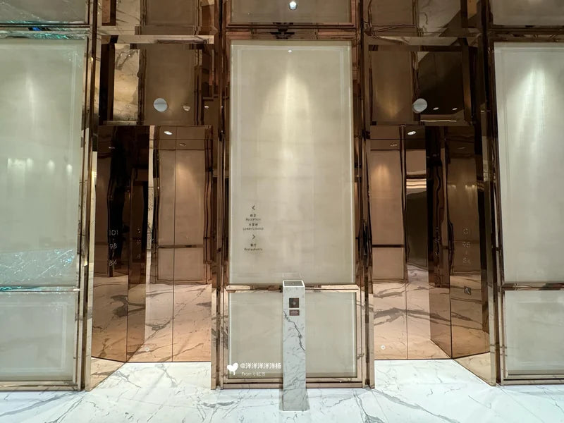 Reflective metal elevator door surrounds in hotel lobby for custom Xinmao Metal elevator design