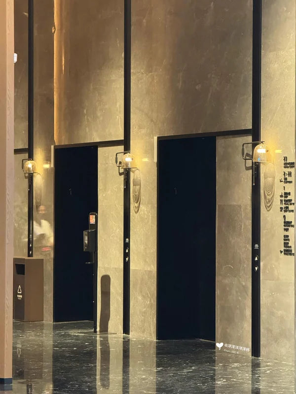 Tall dark elevator portals with illuminated jambs for custom Xinmao Metal elevator design