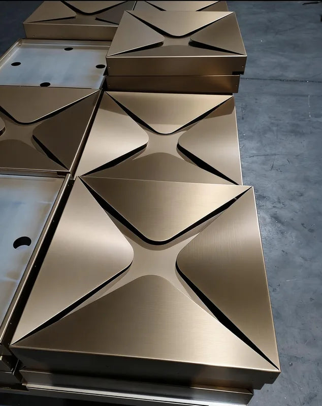 Folded bronze metal soffit modules arranged for geometric canopy