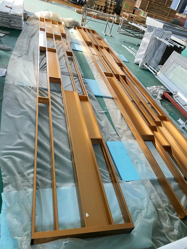 Overall workshop view of gold linear architectural stainless steel screen frame