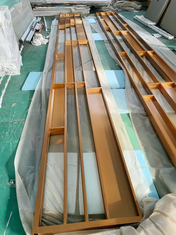 Assembly view of gold linear architectural stainless steel screen frame