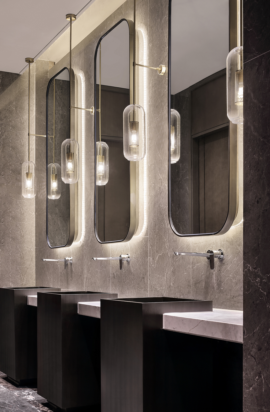 Rounded mirror cabinet panels for a hospitality vanity area