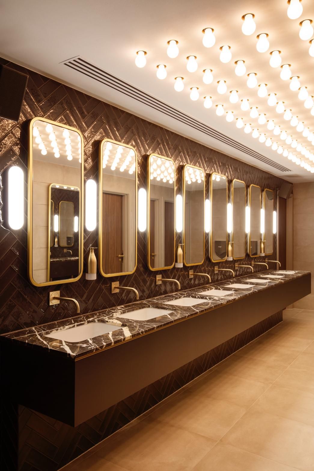 Long rounded illuminated mirror cabinets for a vanity counter