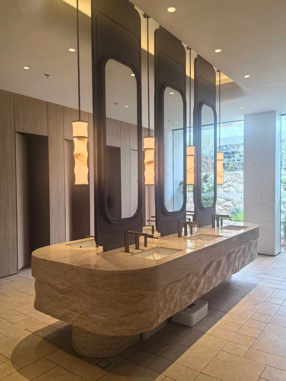 Dark framed mirror cabinet system over a commercial wash counter