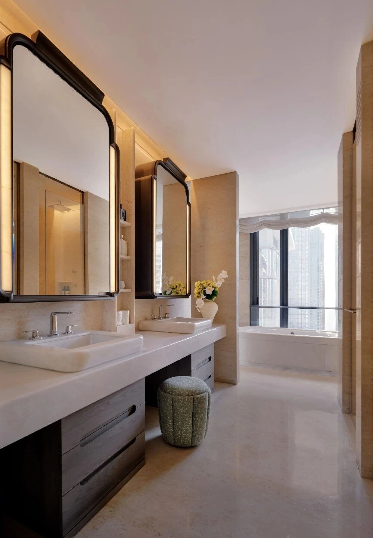 Dark framed mirror cabinets above a hotel vanity