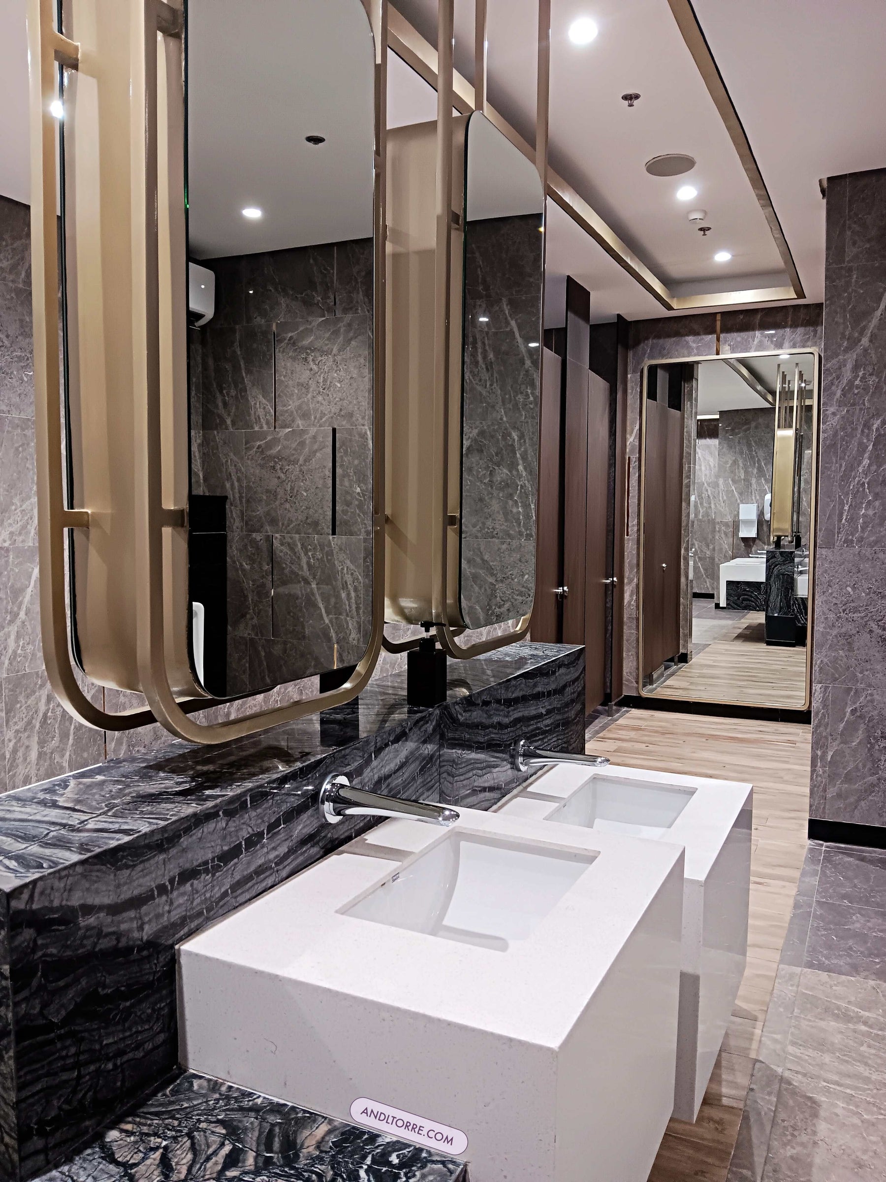 Gold framed commercial mirror cabinets at a multi-station washroom