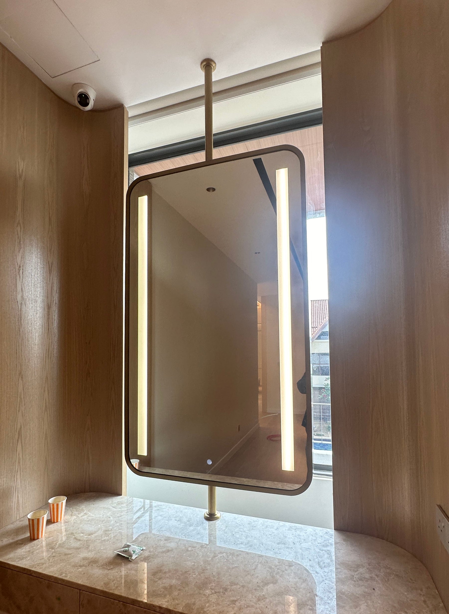Commercial washroom with tall freestanding mirror cabinet panels