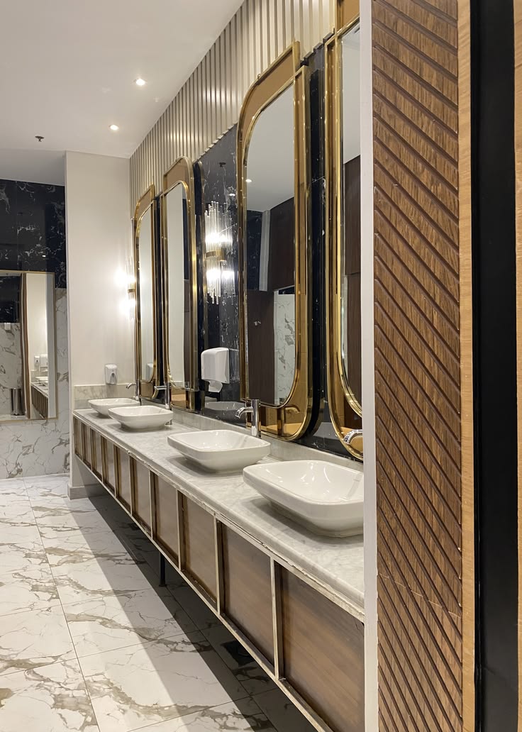 Bronze framed mirror cabinets over twin washbasins