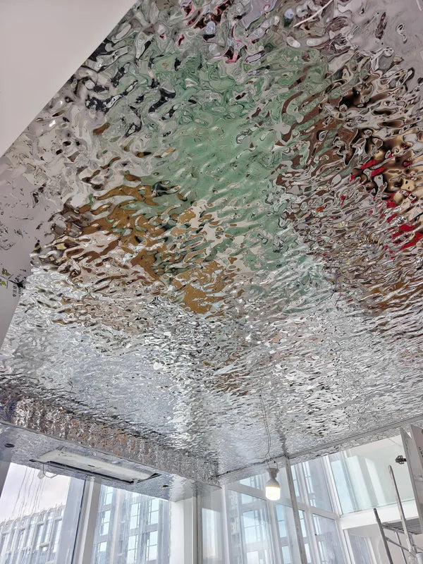 Reflective water ripple kitchen ceiling beside tall windows