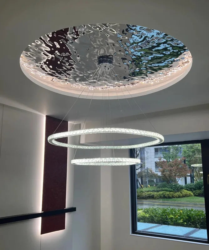 Round reflective ceiling feature over contemporary room
