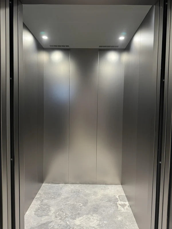 Simple lift cabin with satin metal-look walls for custom Xinmao Metal elevator design