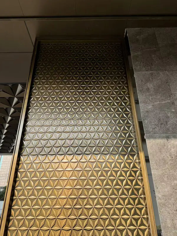 Angled view of Bronze 3D Faceted stainless steel Screen Panel